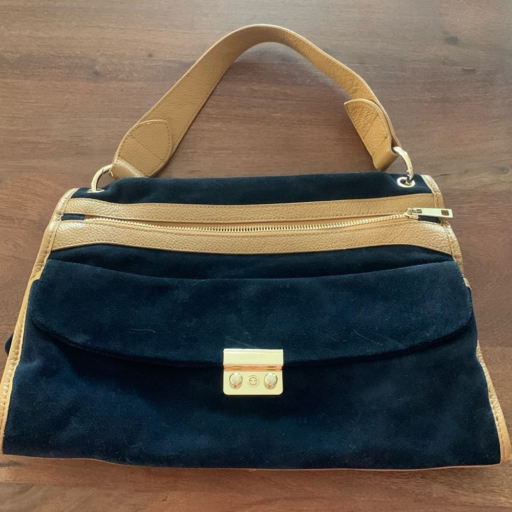 Sooo good!!!Beautiful vintage blue suede handbag with purple suede interior.